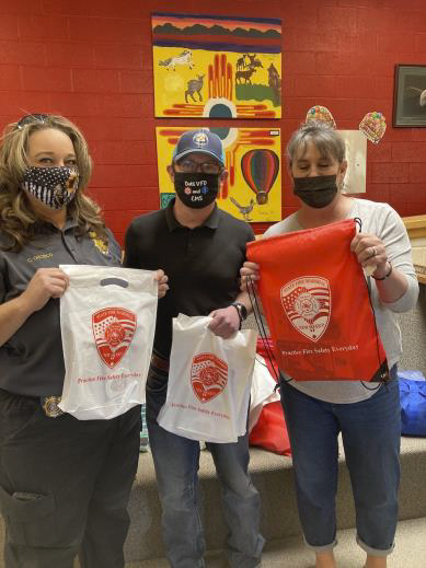 Catron1 Three people in masks displaying tshirts
