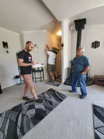 Two men standing inside a home