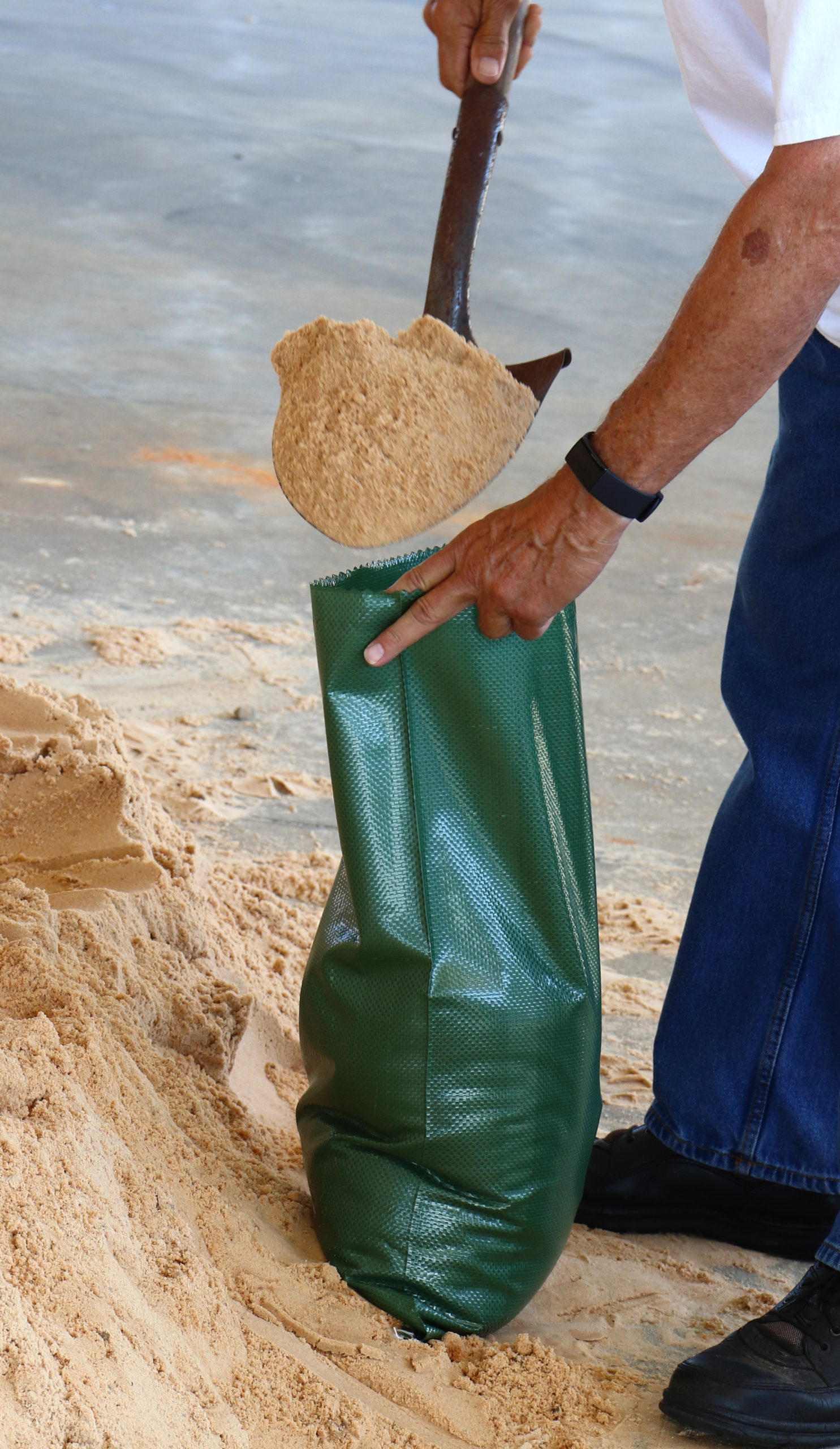 man filling sand bag